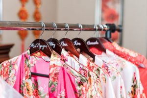 Bridesmaids robes on personalized hanger during wedding day preparation