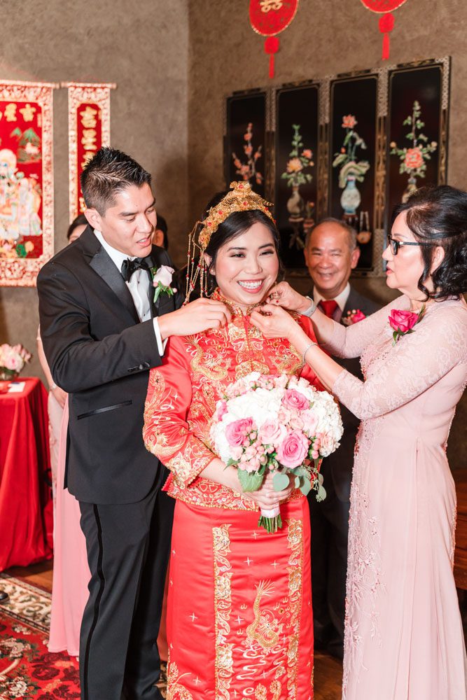 Bride gets a gift during the Chinese and Vietnamese tea ceremony at her wedding day in Oklahoma City