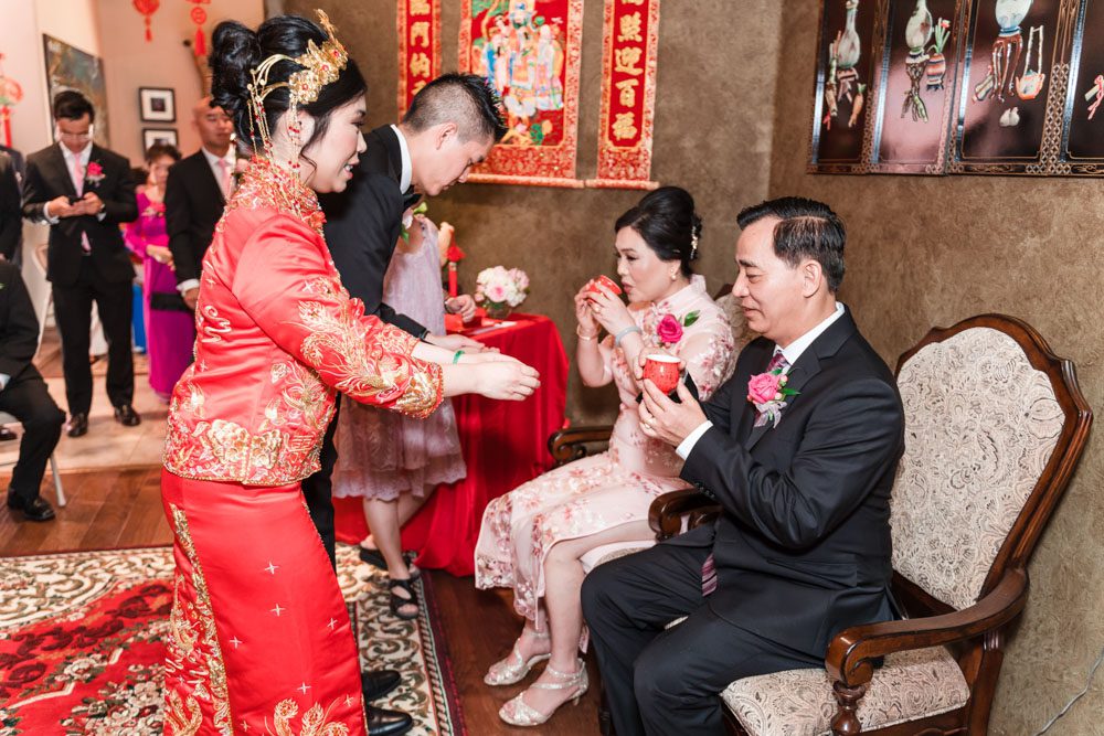 Bride and groom present tea during the traditional Asian ceremony on their wedding day captured by Orlando wedding photographers