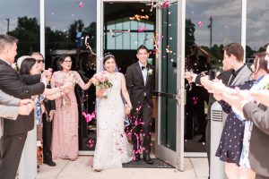 Bride and groom have their grand exit with confetti as they leave the church in Oklahoma City captured by top Orlando wedding photographers