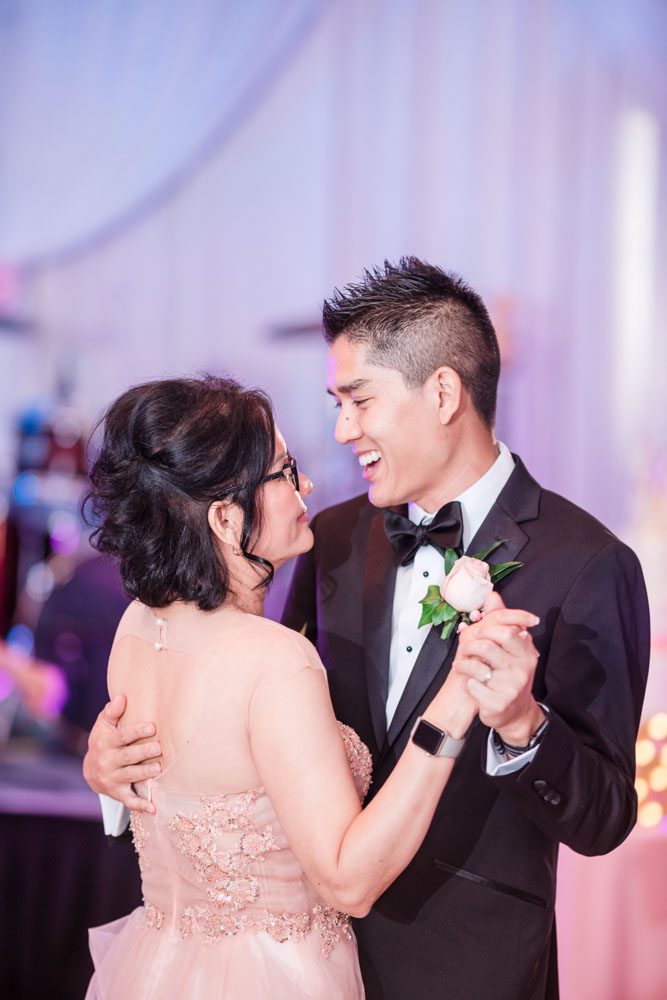Top Orlando wedding photographers captures the groom dancing with his mom at Hy Palace in Oklahoma