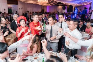 Chinese bride and Vietnamese groom share a toast with their guests at Hy Palace wedding in Oklahoma captured by traveling photographers from Orlando