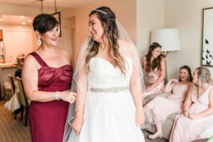 Top Orlando wedding photographer captures bride getting ready with her mom for her wedding day at the Crystal Ballroom veranda