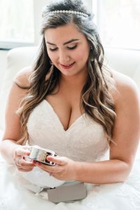Bride opening her wedding day gift captured by best Orlando photographer and videographer team