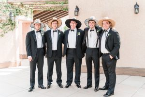 Fun portrait of the groomsmen wearing hats during an Orlando Summer wedding at Crystal Ballroom