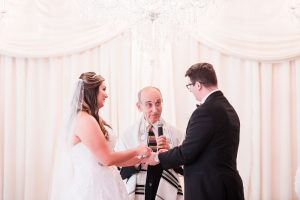 Bride and groom exchange vows during their Jewish wedding at the Crystal Ballroom captured by Orlando wedding photographer