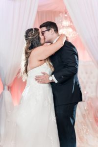 Newlyweds share their first dance at the Crystal Ballroom Veranda wedding venue in Orlando, Florida