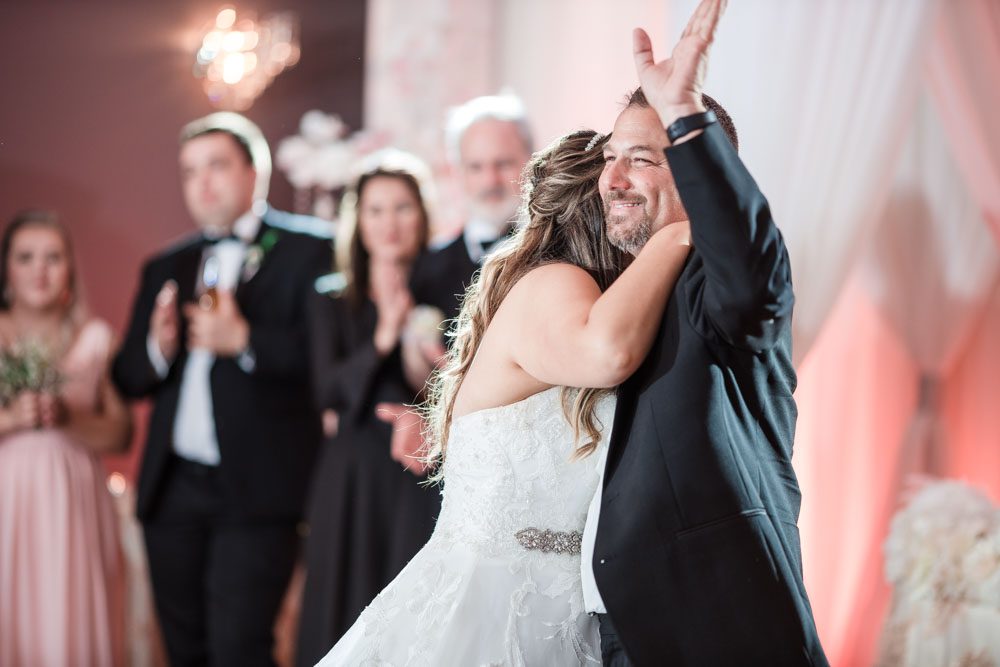 Bride and her dad share their first dance at the Crystal Ballroom Veranda wedding venue in Orlando, Florida