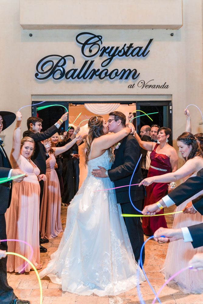 Couple has a grand exit with glow sticks at the Crystal Ballroom wedding venue in Orlando, Florida