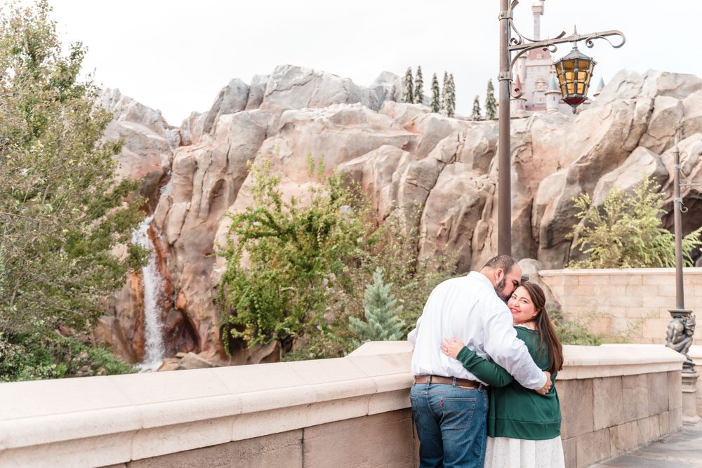 Disney engagement photo in front of the Beauty and the Beast castle in Magic Kingdom in Orlando