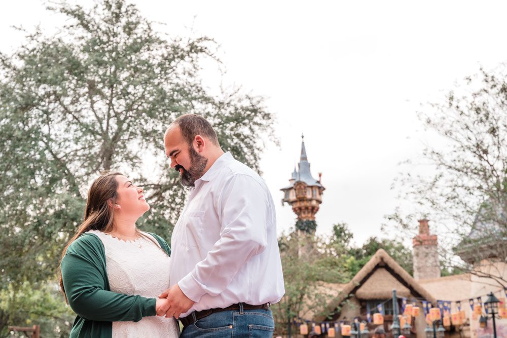 Engagement photography session in front of Rapuzel's tower in the Tangled area of Walt Disney World