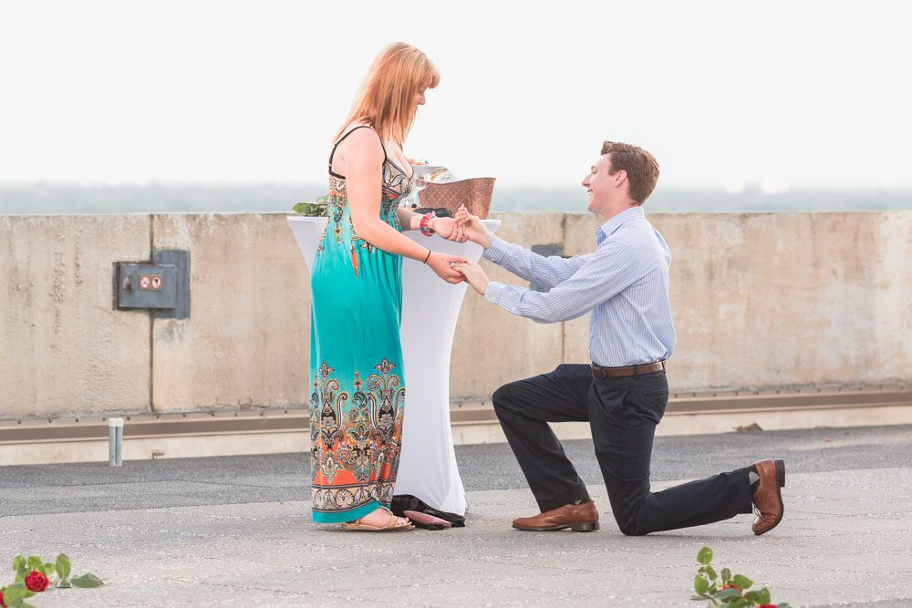 Orlando engagement photographer captures surprise proposal at The Balcony in downtown with skyline views at sunset