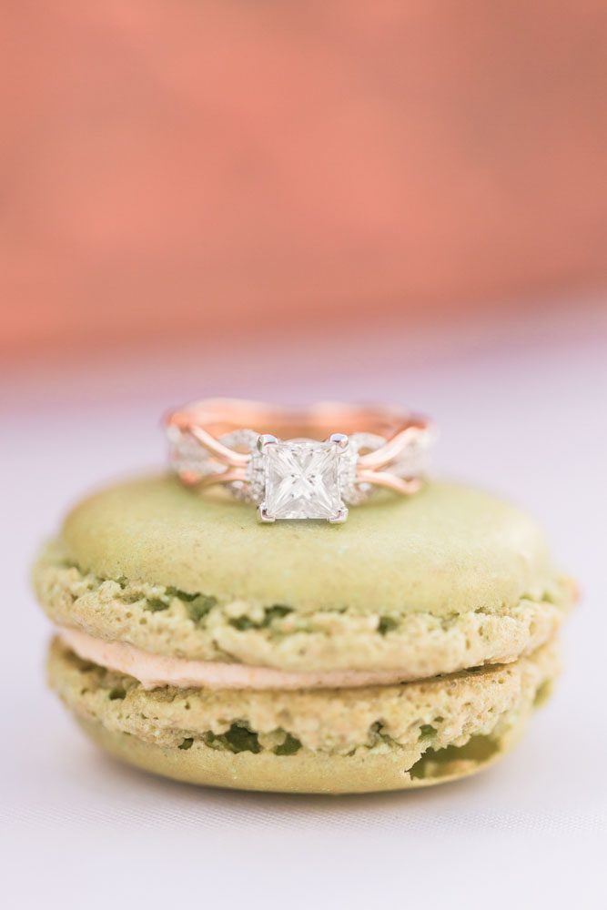 Gold diamond engagement ring on a macaroon during a surprise proposal in Orlando