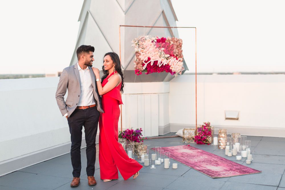 Orlando engagement photographer captures a surprise proposal at The Castle Hotel with sunset views of the ferris wheel