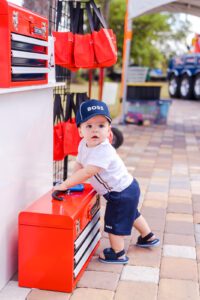 Birthday portrait in front of toolbox during first birthday event in Orlando Florida