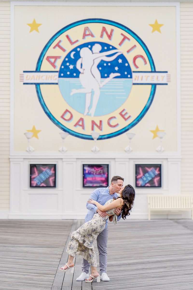 Whimsical engagement photo taken at Atlantic Dance Hall at Disney Boardwalk Inn Orlando