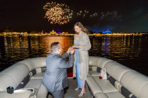 Surprise proposal photography on Disney fireworks boat cruise captured by top Orlando engagement photographer