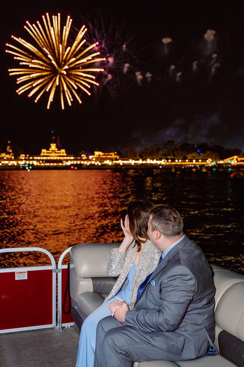 Dream fireworks proposal with Disney Magic Kingdom view from boat tour captured by top Orlando proposal photographer