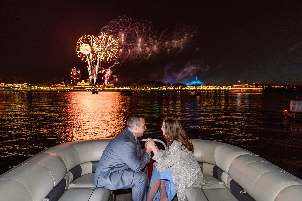 Emotional moment at a surprise proposal with fireworks at Disney World in Orlando, Florida by top engagement photographer