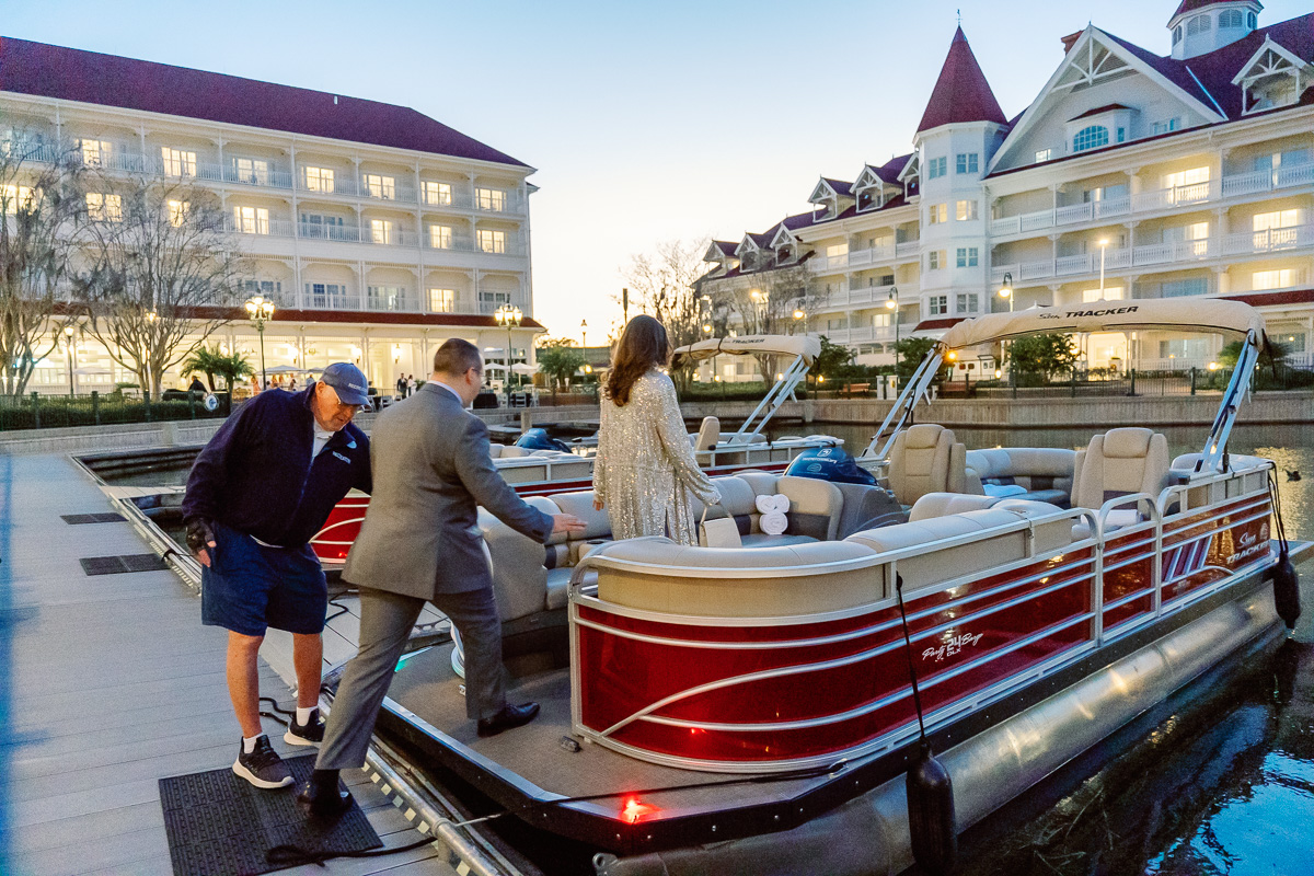 Couple boarding fireworks boat tour at Grand Floridian for a surprise marriage proposal captured by top Orlando photographer