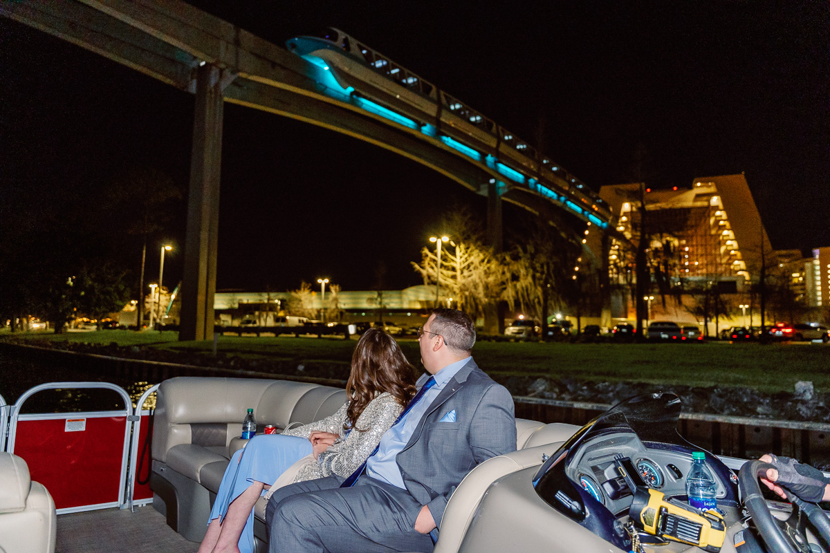 Monorail passes over boat tour during surprise proposal photography at Disney