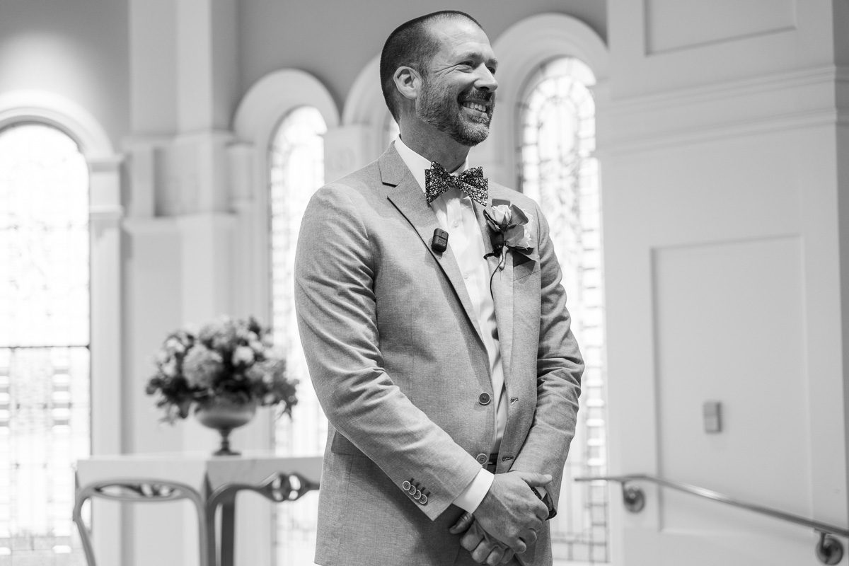 Groom awaiting the bride at Disney's Wedding Pavilion venue captured by the best Orlando wedding photographer and videographer