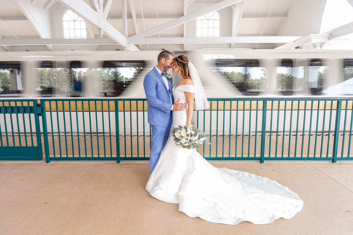 Wedding portrait with the monorail at Disney's Grand Floridian resort by top Orlando wedding photographer and videographer
