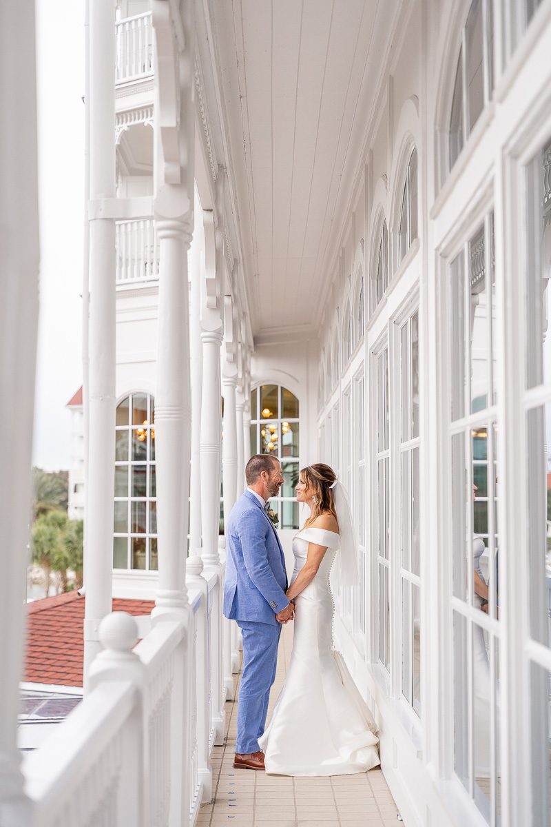 Disney wedding portraits outside of Citricos at the Grand Floridian by top Disney wedding photographer and videographer