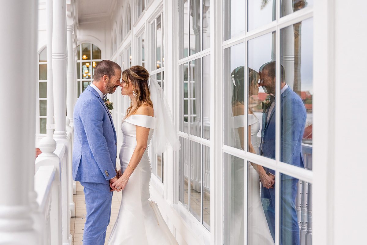 Disney wedding portraits outside of Citricos at the Grand Floridian by top Disney wedding photographer and videographer