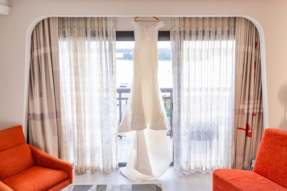 Dress hanging in the window of the Contemporary Resort at Disney World captured by top Orlando wedding photographer and videographer