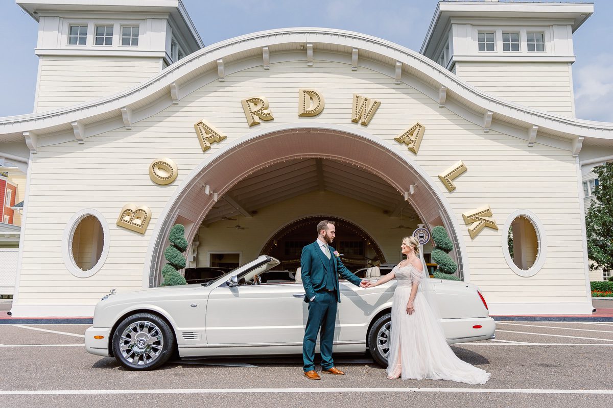 Disney wedding photography at Boardwalk Inn with luxury Bentley convertible car captured by top Orlando wedding photographer & videographer