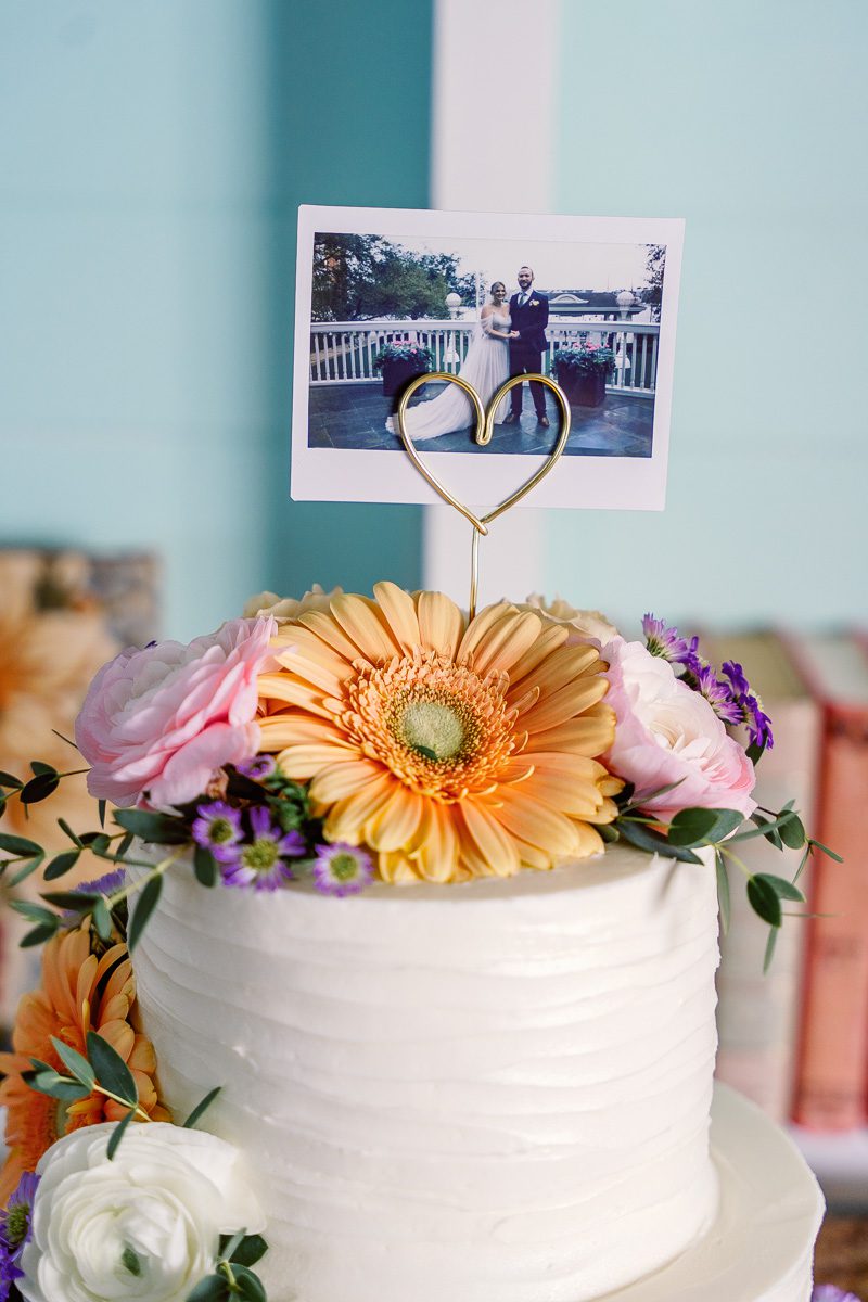Polaroid cake topper at intimate wedding at The Attic Boardwalk Inn by top Disney wedding photographer