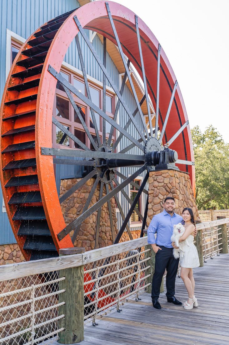 Port Orleans Riverside engagement session with adorable dog in front of the water wheel