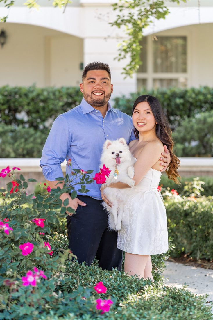 Port Orleans Riverside engagement session with adorable dog at the water fountain in front of flowers