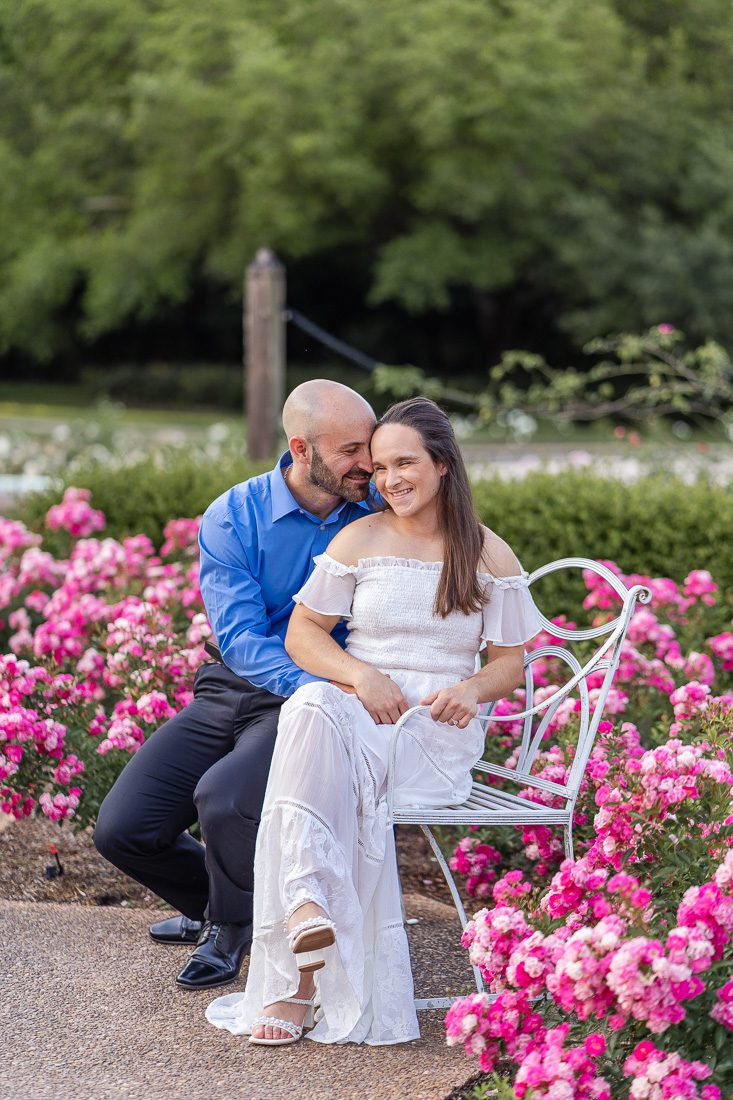 Dreamy engagement session on a bench in a rose garden with top ranking Orlando photographer