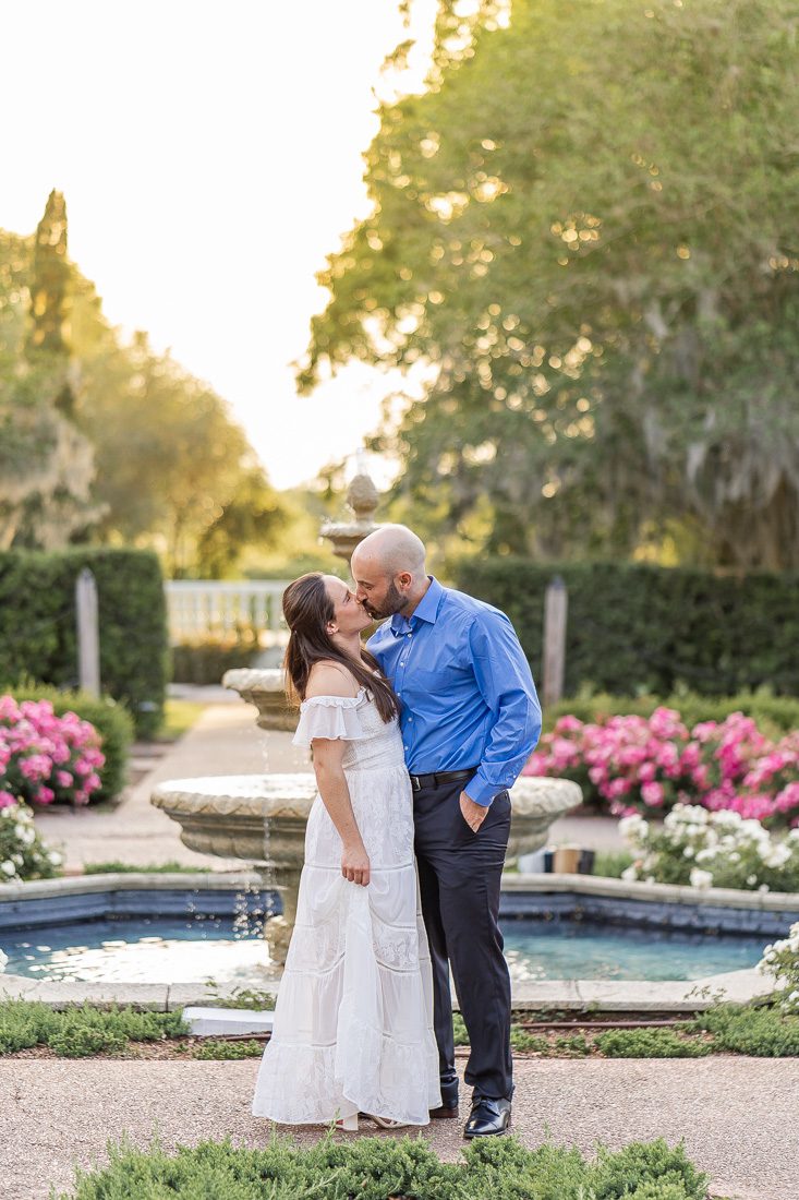 Sunset engagement session in front of a fountain in a rose garden with top Orlando photographer