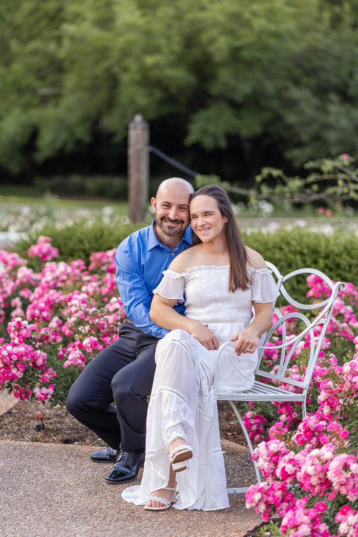 Orlando engagement photographer captures a romantic photoshoot at Leu Gardens with a water fountain, blooming flowers and lush greenery