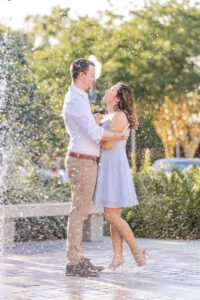 Creative dramatic engagement photo with a water fountain by top Orlando engagement photographer Elle Baez