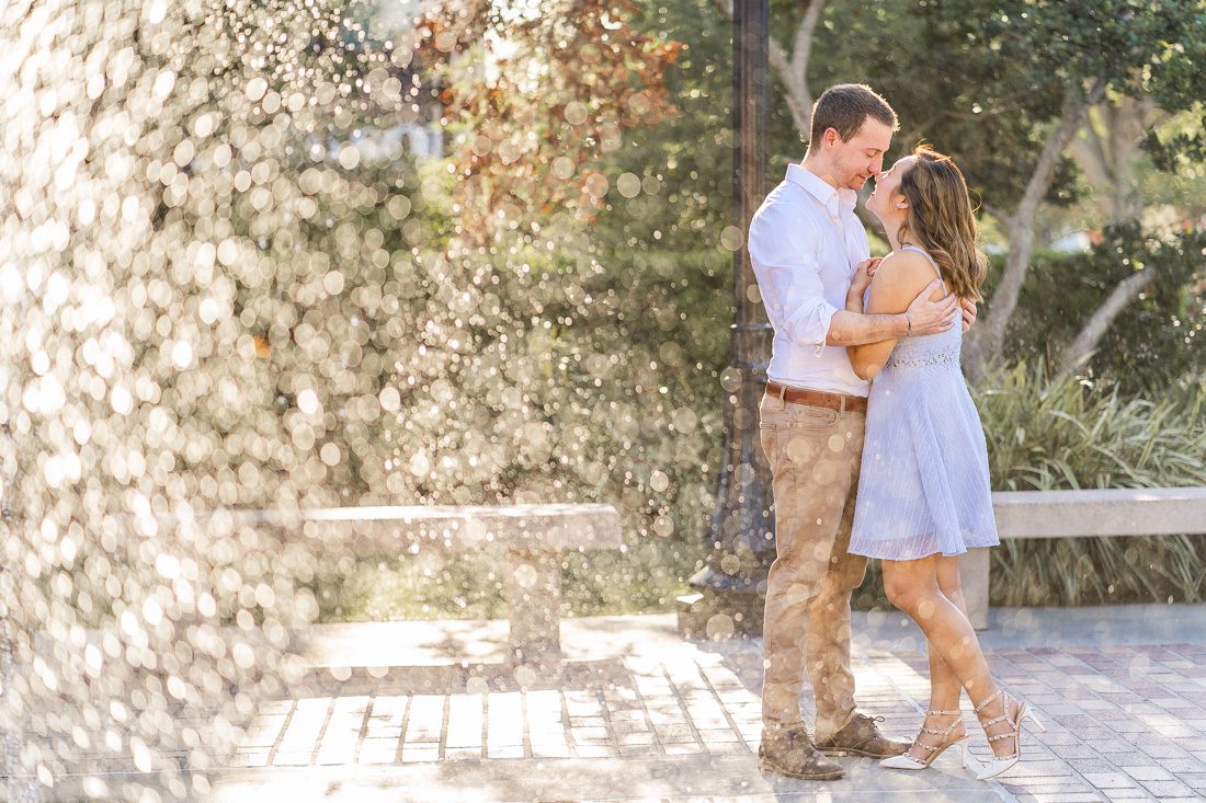 Creative dramatic engagement photo with a water fountain by top Orlando engagement photographer Elle Baez