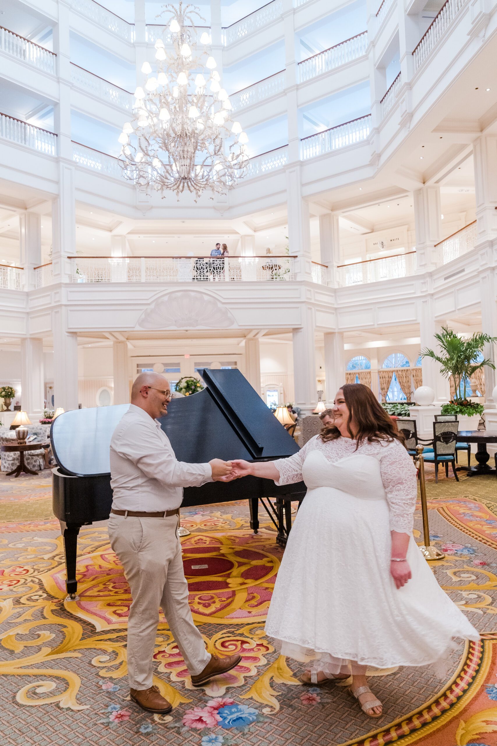 Engagement photo inside the Grand Floridian lobby with the piano during a photoshoot with top Disney photographer