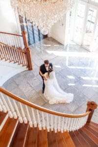 Romantic first look on staircase at Luxmore Grande Estate venue near Orlando Florida