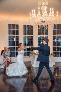 Joyful fun romantic reception photos with a creative shutter drag and dancing by top Orlando photo and video