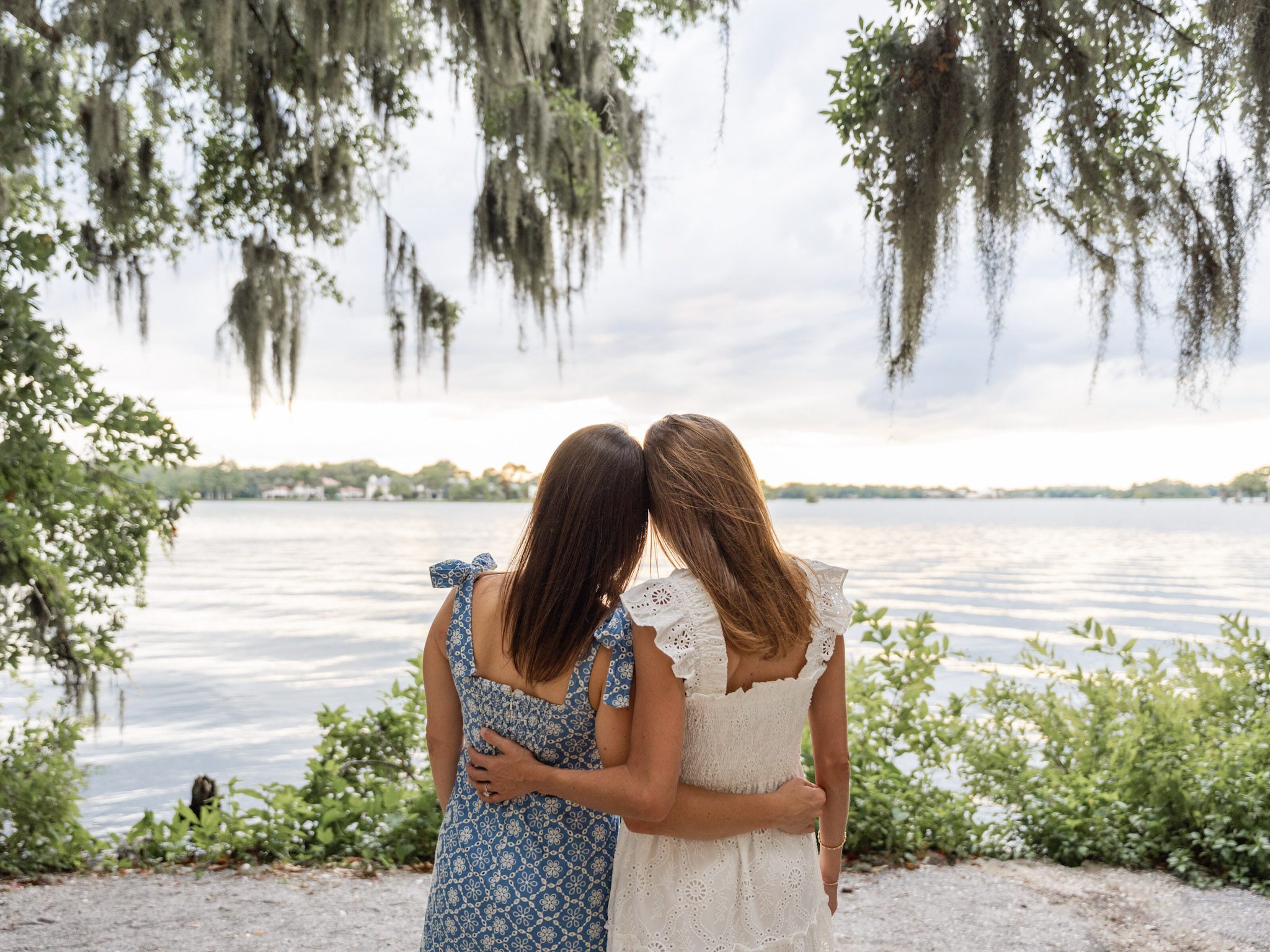 Looking over to the sunset while holding each other close. Beautiful moment captured in Kraft Azalea Park by top Orlando wedding photo and video