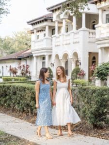 LGBTQ couple in love walking hand in hand during engagement session in Kraft Azalea park captured by Orlando Top wedding photographer