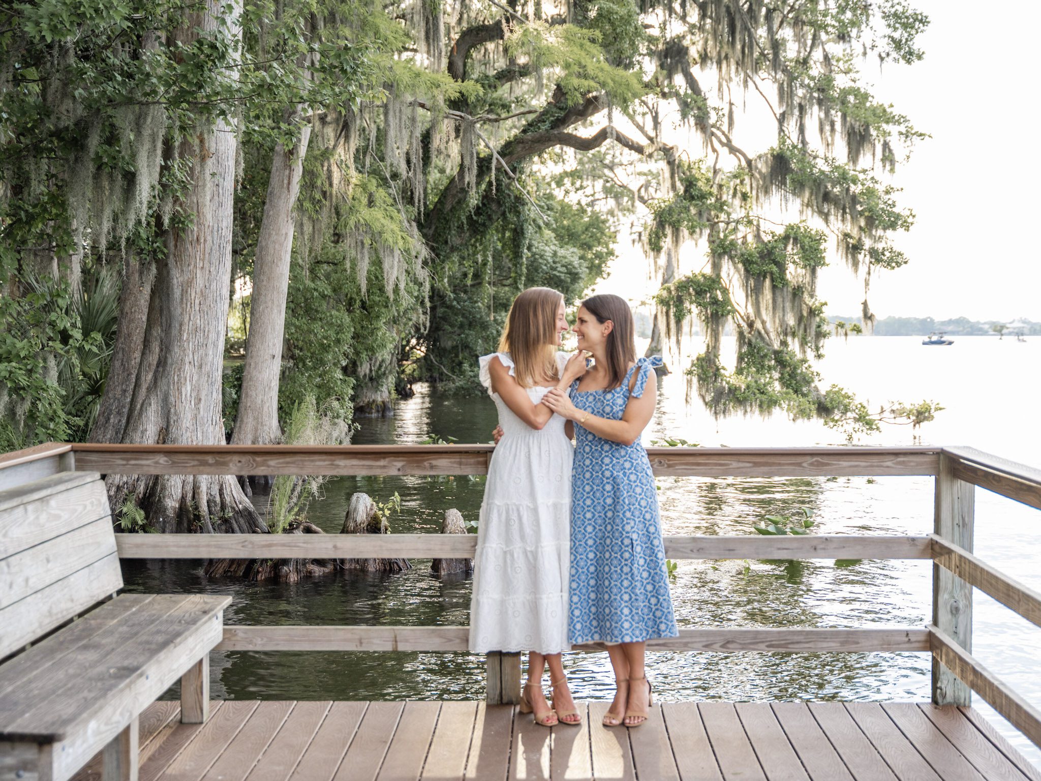 Close up portrait of a joyful LGBTQ couple in light summer dresses, holding hands during their engagement session by top Orlando Wedding Photographer