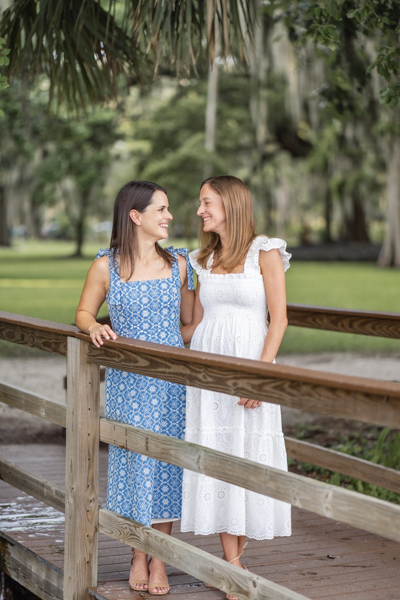 Wrapped in each other’s gaze, time seems to slow as their love shines through. Beautiful blue and white summer dress in Kraft Azalea Park in Orlando captured moment by top Orlando wedding photographer