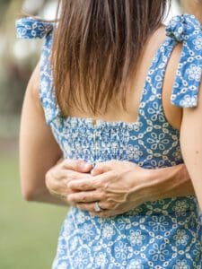 Moment captured by Orlando Top Wedding Photographer hands around waist with engagement ring, same-sex couple