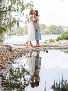 Romantic engagement photo of a same-sex couple silhouetted by the evening sun at Kraft Azalea Park by top Orlando wedding photographer