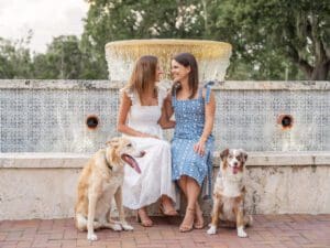 LGBTQ couple smiling with their two dogs during an engagement session in Orlando, Florida by Top Wedding Photographer
