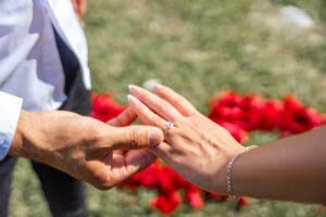 Romantic Lake Eola surprise proposal setup featuring red rose petals photographed in downtown Orlando.